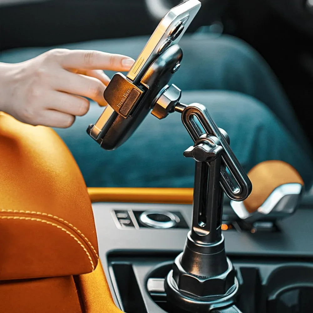 Hand adjusting a car phone holder on a car dashboard