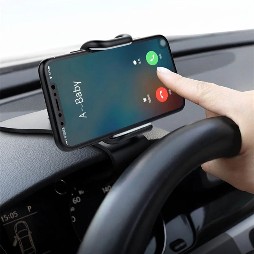 Phone mounted on a car dashboard with a hand interacting with the screen