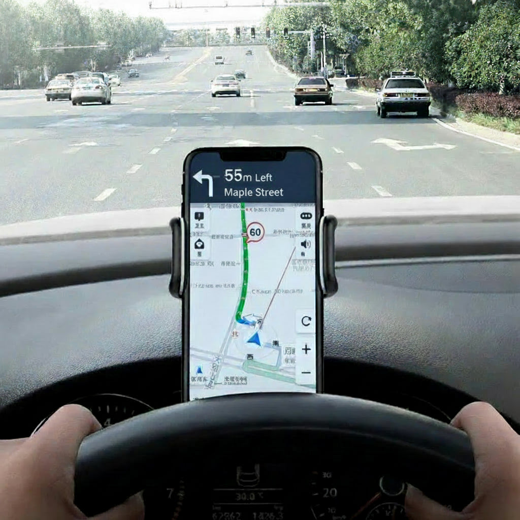 Person driving a car with a smartphone displaying a navigation app on the dashboard.