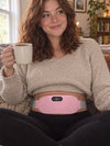 EmberWrap customer-style photo: woman wearing the pink heat belt on her lower belly